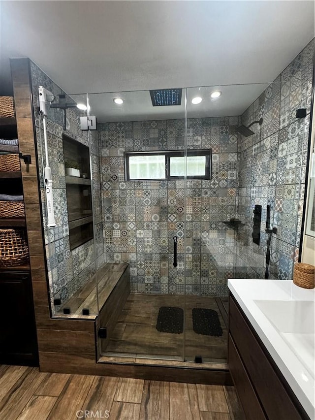 bathroom with visible vents, a stall shower, vanity, and wood finished floors