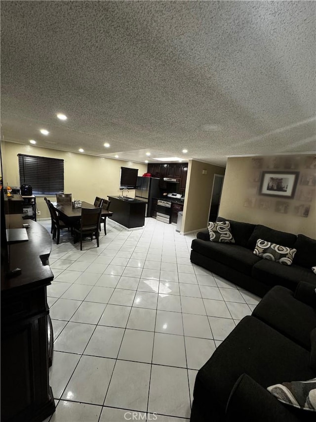 living room featuring light tile patterned flooring, recessed lighting, and a textured ceiling