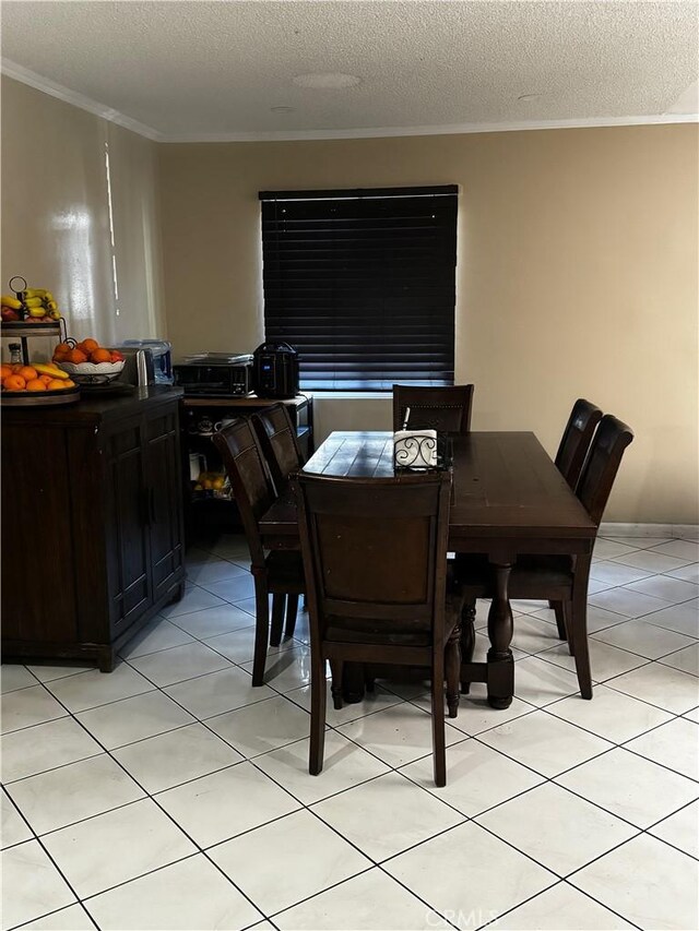 dining space with crown molding, light tile patterned floors, and a textured ceiling