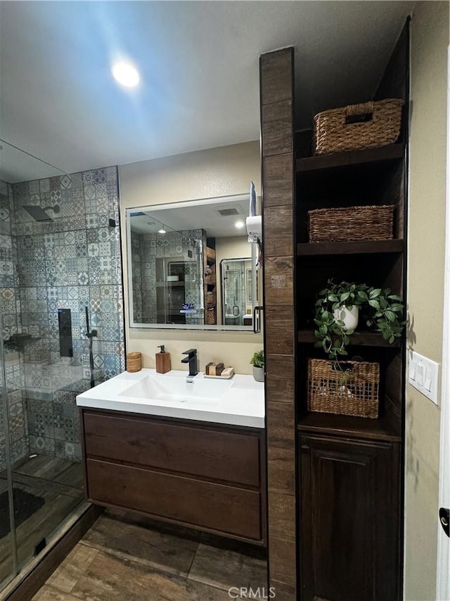 full bath with a shower stall, vanity, and wood finished floors