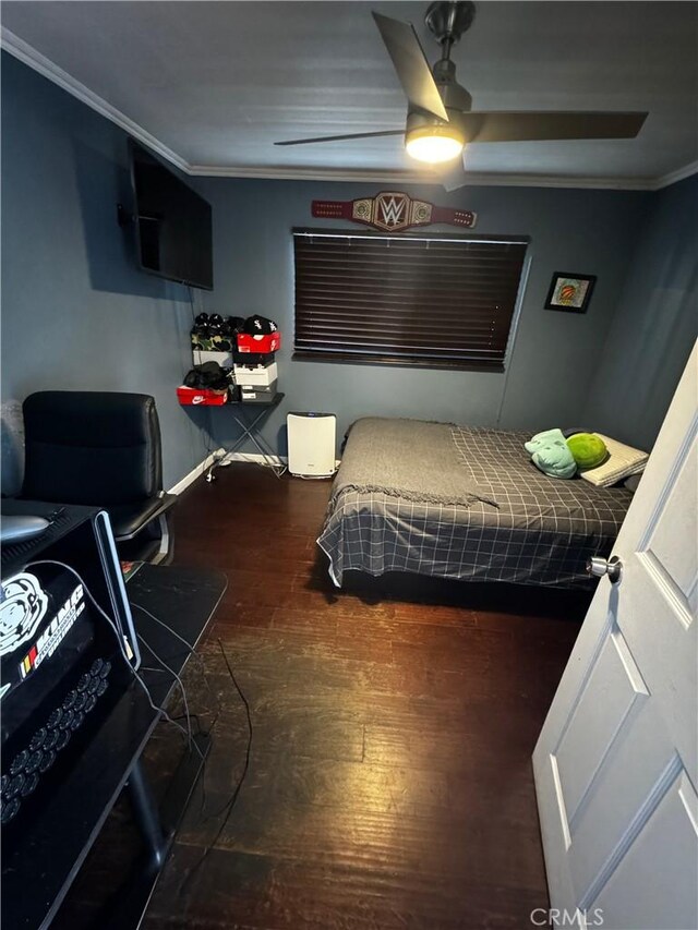 bedroom with a ceiling fan, crown molding, and wood finished floors