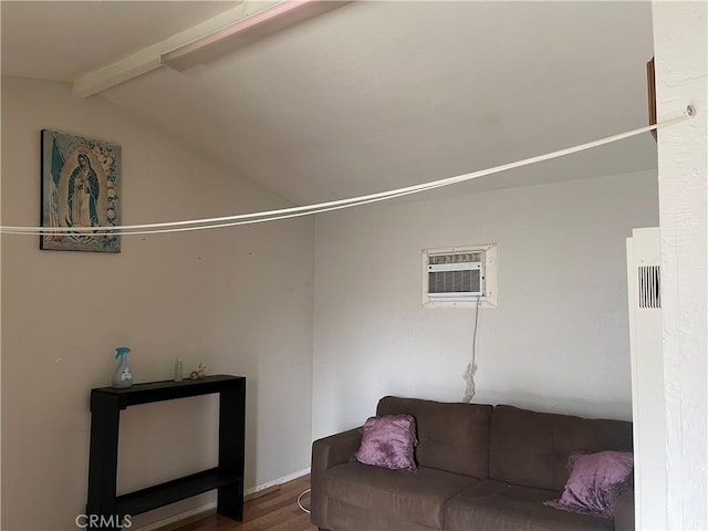 living area with lofted ceiling with beams, wood finished floors, and a wall mounted AC