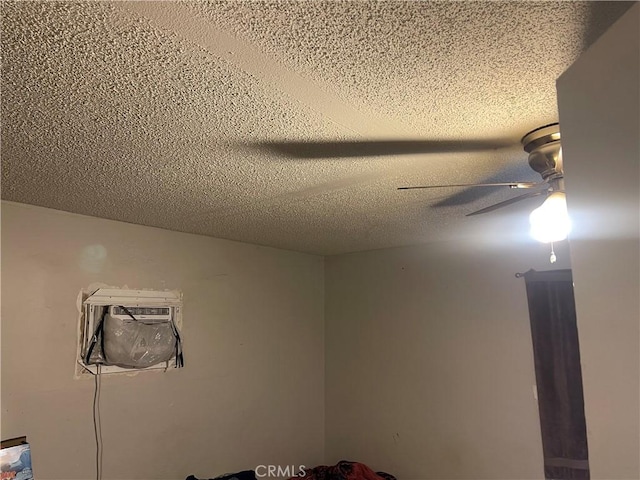 interior details with a textured ceiling and ceiling fan