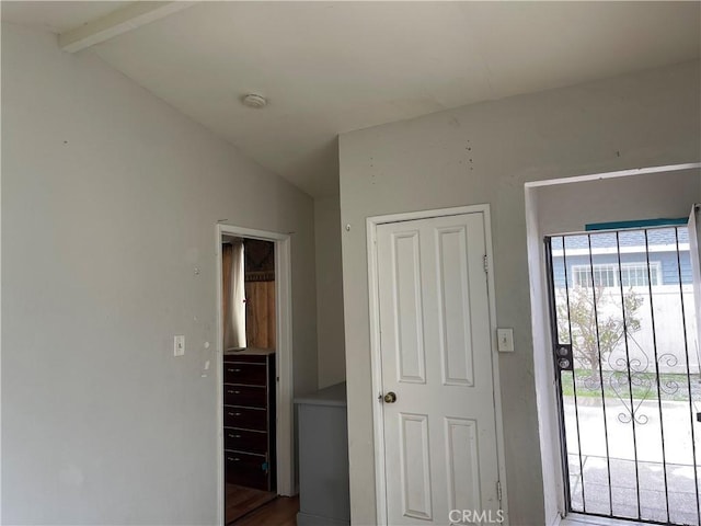 foyer featuring lofted ceiling with beams