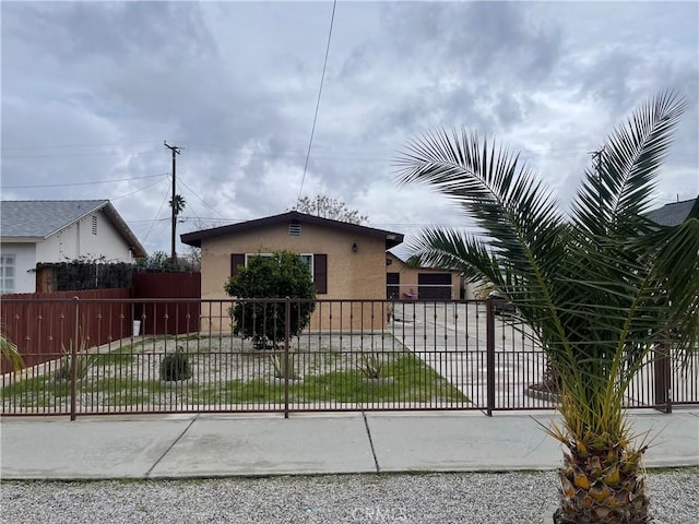 bungalow-style house with fence and stucco siding