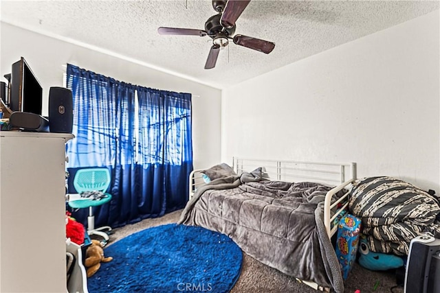 bedroom with a textured ceiling, ceiling fan, and carpet flooring