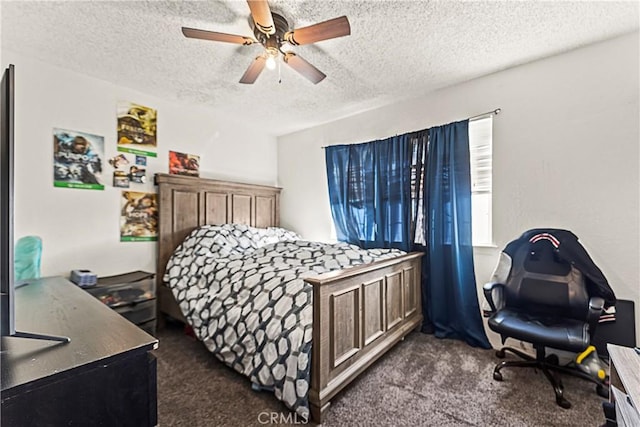 bedroom featuring a ceiling fan, dark carpet, and a textured ceiling