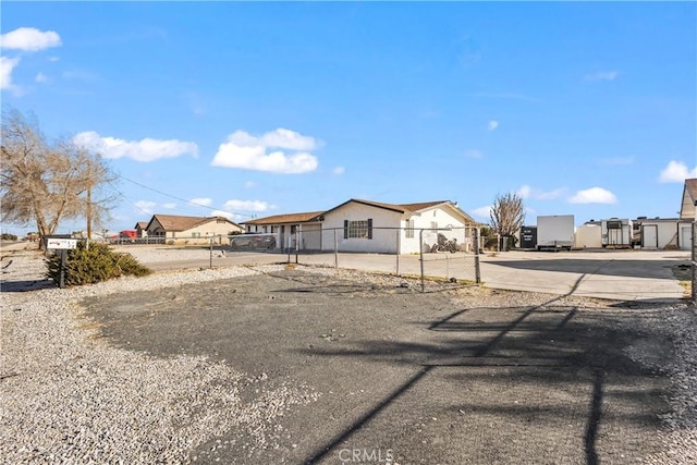 exterior space with driveway and a fenced front yard