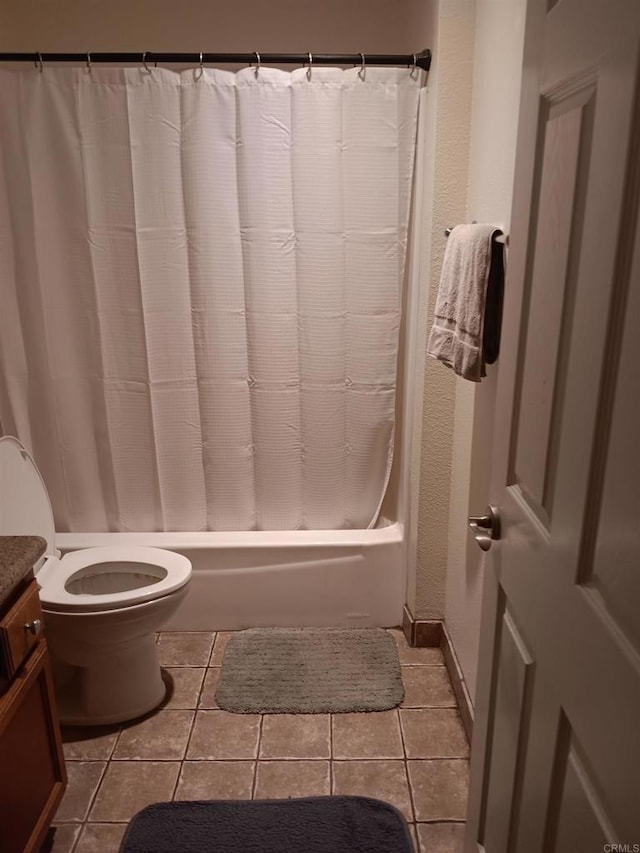 full bathroom with toilet, tile patterned flooring, shower / bath combination with curtain, vanity, and a textured wall