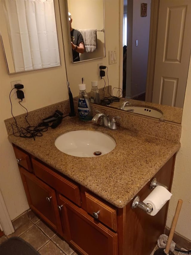 bathroom featuring tile patterned flooring and vanity