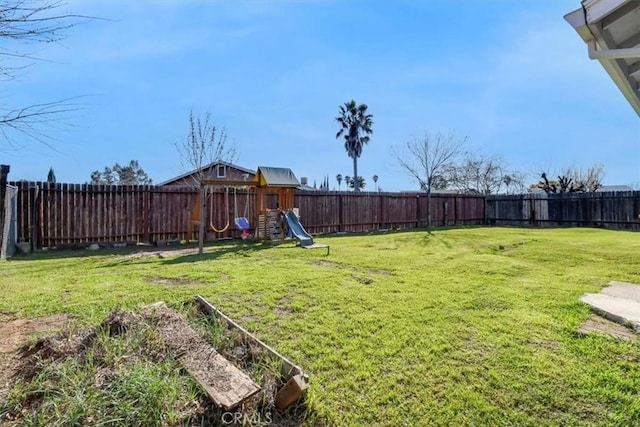 view of yard featuring a playground and a fenced backyard