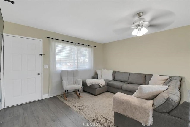 living room with wood finished floors and ceiling fan