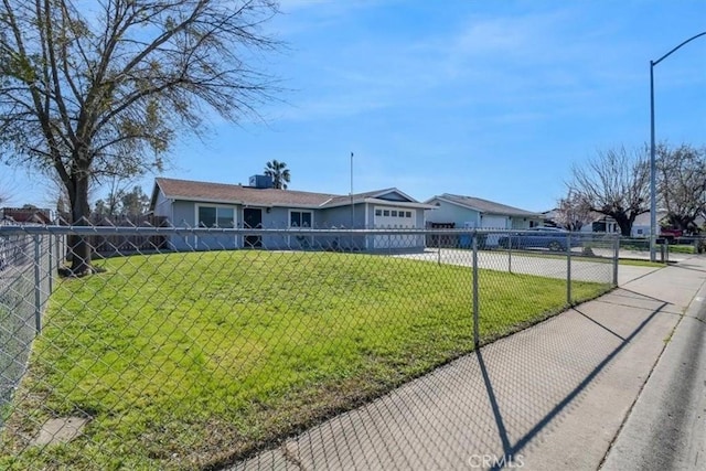 view of front of home featuring a fenced front yard, driveway, and a front yard