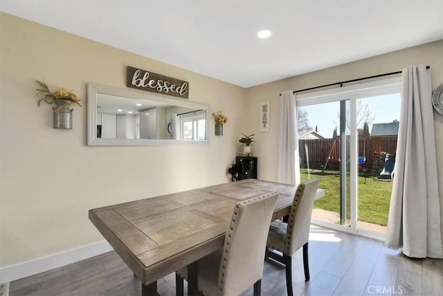 dining space with wood finished floors, baseboards, and a healthy amount of sunlight