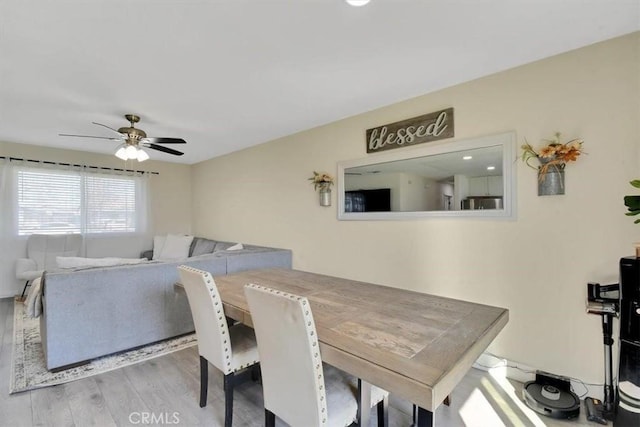 dining area featuring a ceiling fan and wood finished floors