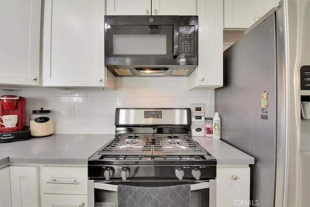 kitchen featuring stainless steel appliances, white cabinetry, tasteful backsplash, and light countertops