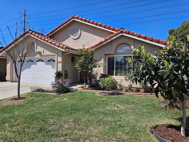 mediterranean / spanish house featuring stucco siding, a front yard, concrete driveway, and an attached garage