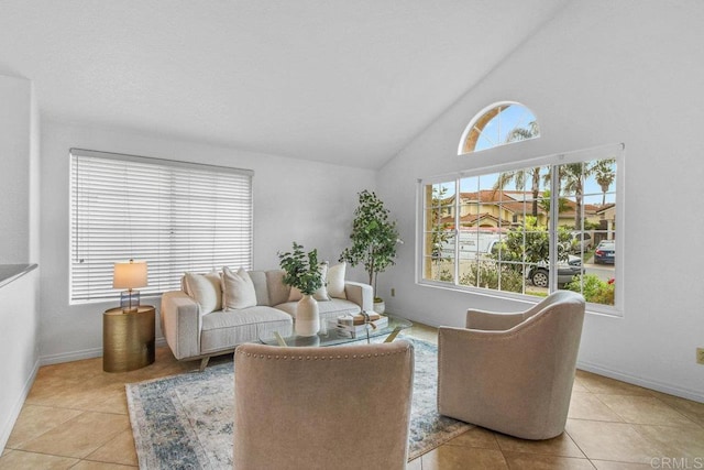 tiled living room with vaulted ceiling and baseboards