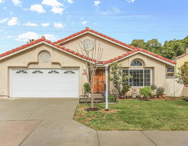 mediterranean / spanish-style house with an attached garage, a tiled roof, a front yard, stucco siding, and driveway