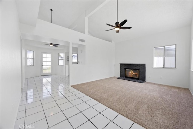 unfurnished living room featuring a ceiling fan, visible vents, high vaulted ceiling, and light tile patterned flooring