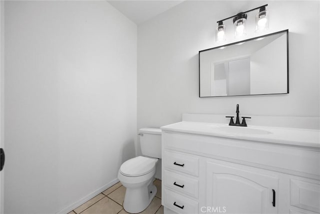 bathroom with tile patterned floors, baseboards, toilet, and vanity