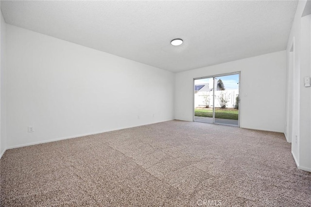 empty room featuring carpet floors and a textured ceiling