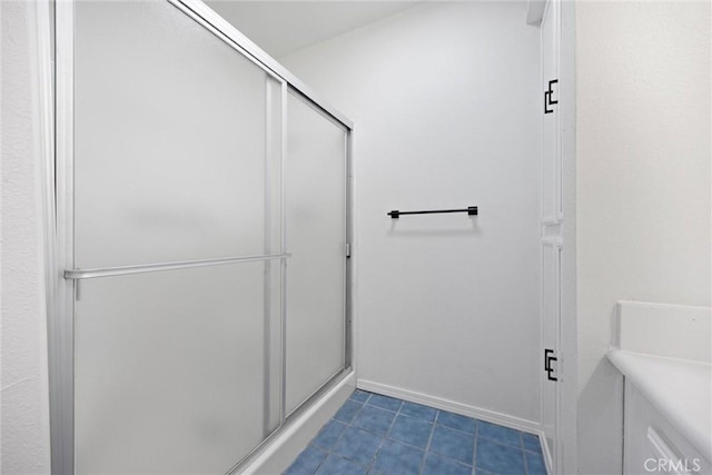 2100 Butterfield Ave, Bakersfield, CA 93304 - full bathroom featuring a stall shower, tile patterned flooring, and baseboards