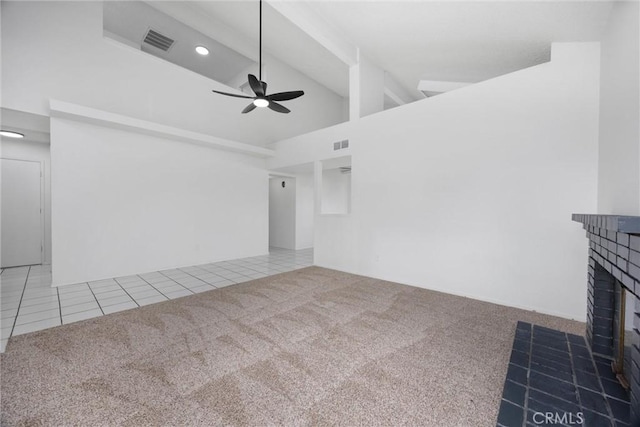 unfurnished living room featuring carpet flooring, visible vents, a ceiling fan, a brick fireplace, and high vaulted ceiling