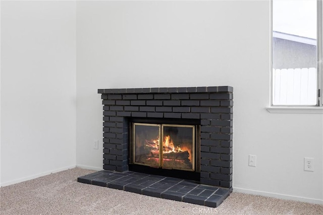 details featuring carpet flooring, a fireplace, and baseboards