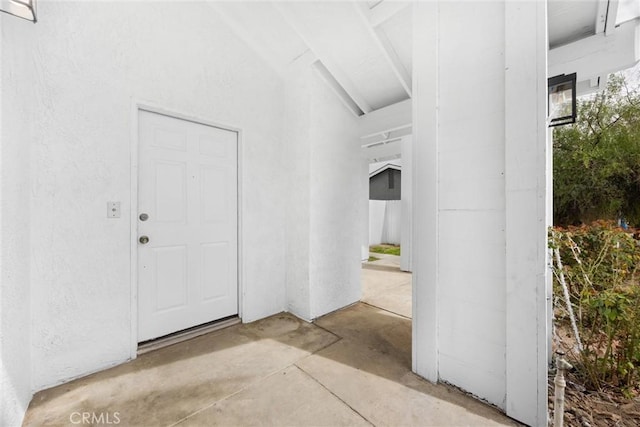 doorway to property featuring stucco siding