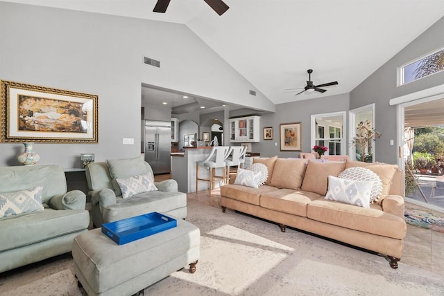 living room with visible vents, high vaulted ceiling, and ceiling fan