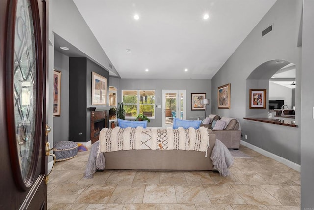 bedroom featuring visible vents, a sink, a fireplace, baseboards, and access to exterior