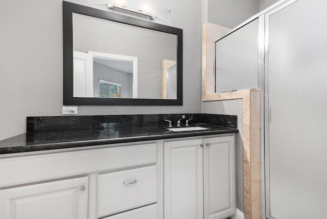 bathroom featuring a stall shower and vanity