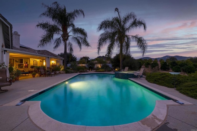 view of pool featuring a patio and a pool with connected hot tub