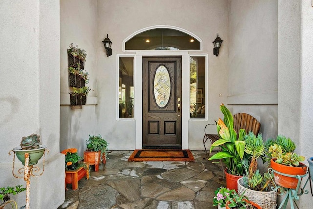 property entrance with stucco siding