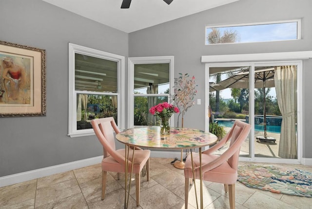 dining room with lofted ceiling, a ceiling fan, baseboards, and a sunroom