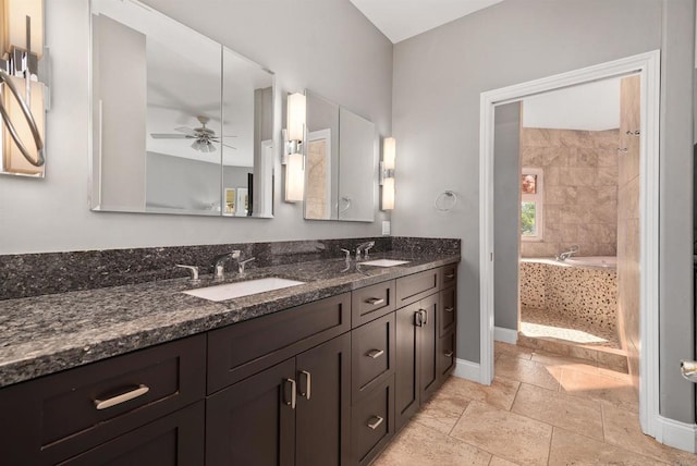 full bathroom with a sink, baseboards, a ceiling fan, and double vanity