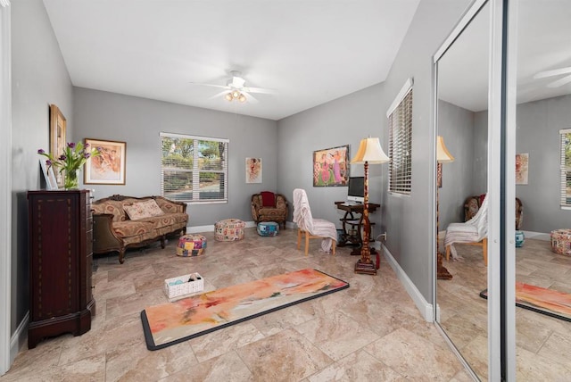 game room featuring baseboards and ceiling fan