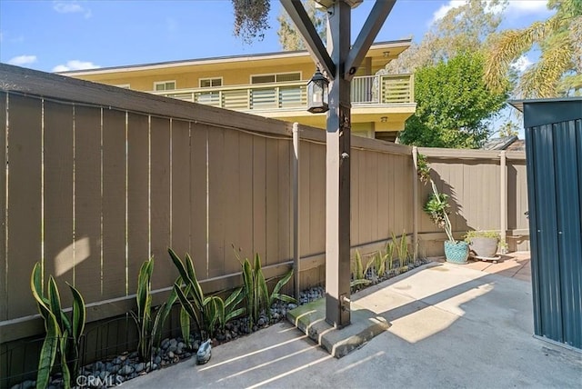 view of patio featuring fence