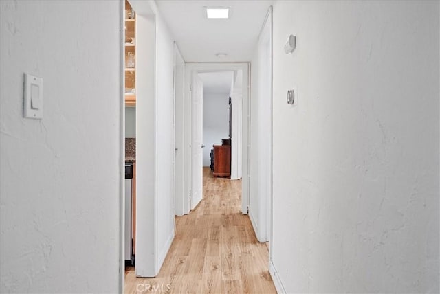 corridor featuring light wood finished floors