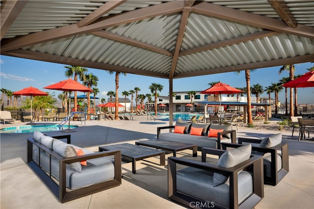 view of home's community with outdoor lounge area, a patio, and a swimming pool