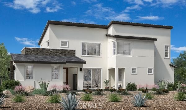 back of house with stucco siding