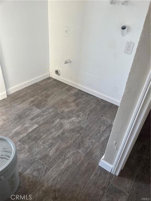 laundry area featuring wood finished floors and baseboards