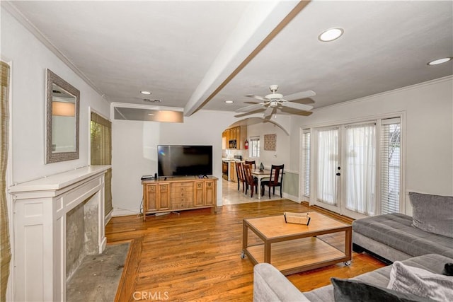 living area featuring recessed lighting, french doors, crown molding, and wood finished floors