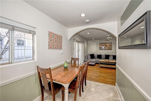 dining area with light tile patterned floors, recessed lighting, arched walkways, and ceiling fan