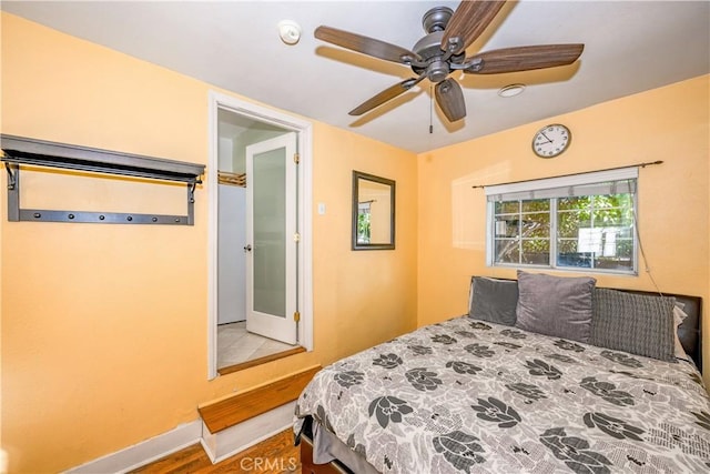 bedroom featuring baseboards and ceiling fan