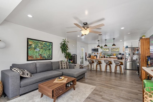 living area featuring recessed lighting, light wood-style flooring, and ceiling fan