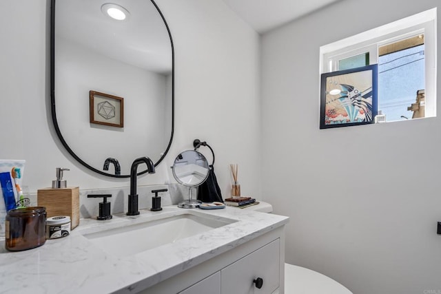 bathroom with toilet and vanity