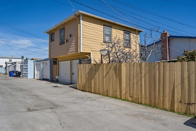 exterior space with fence and a garage