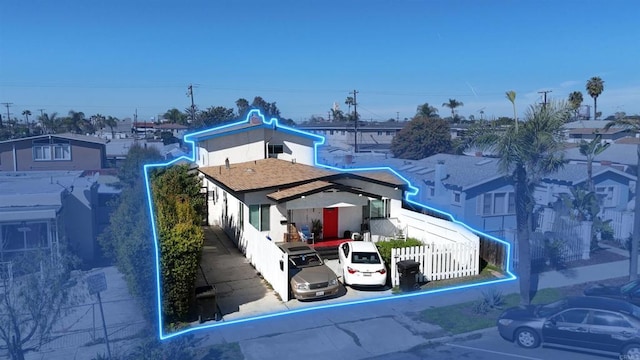 rear view of house featuring fence